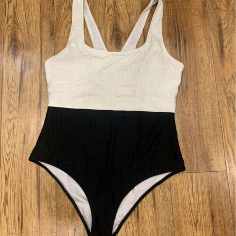 WOMAN’S one piece swimsuit. Black and white. Racerback. White portion is lined.
